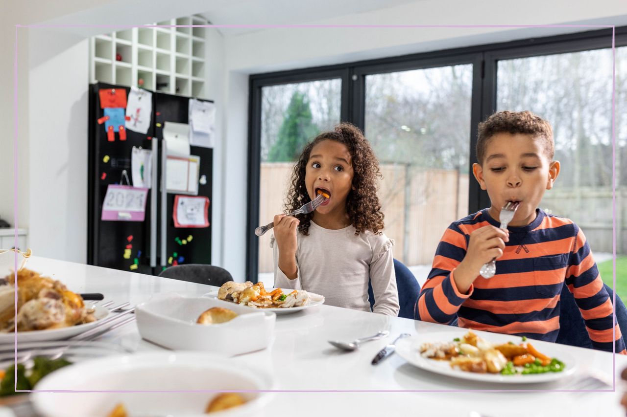 Two children sat at the kitchen table eating their food