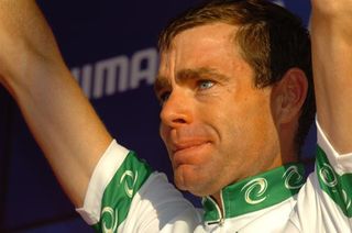 Cadel Evans holds back the tears as he celebrates on the podium.