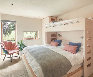 bedroom with bunk bed with double on bottom and single raised single across top