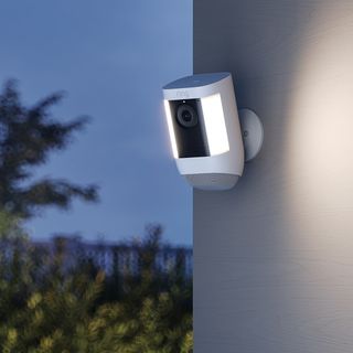The new Ring Spotlight Cam Pro mounted on the side of a home wall.