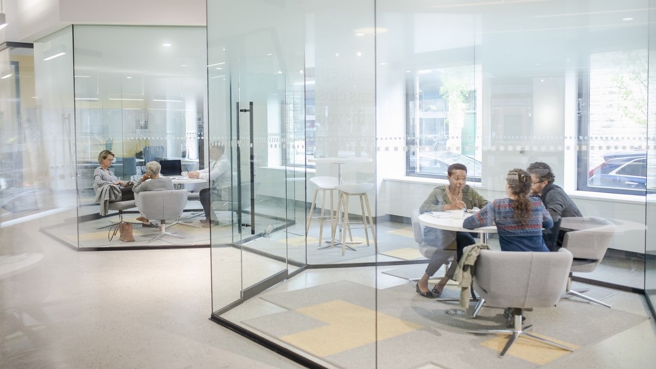 Customers work with representatives at a financial institution.