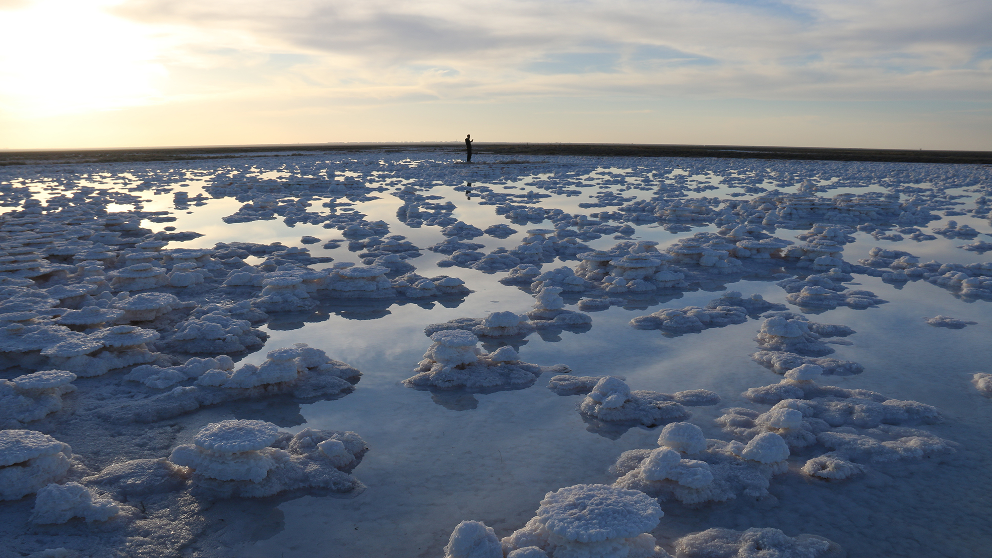 A man walks through salt formations in the receding waters of Lake Tuz in Aksaray, Turkey