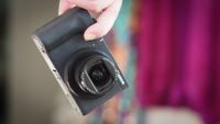 Canon PowerShot being held by fingertips