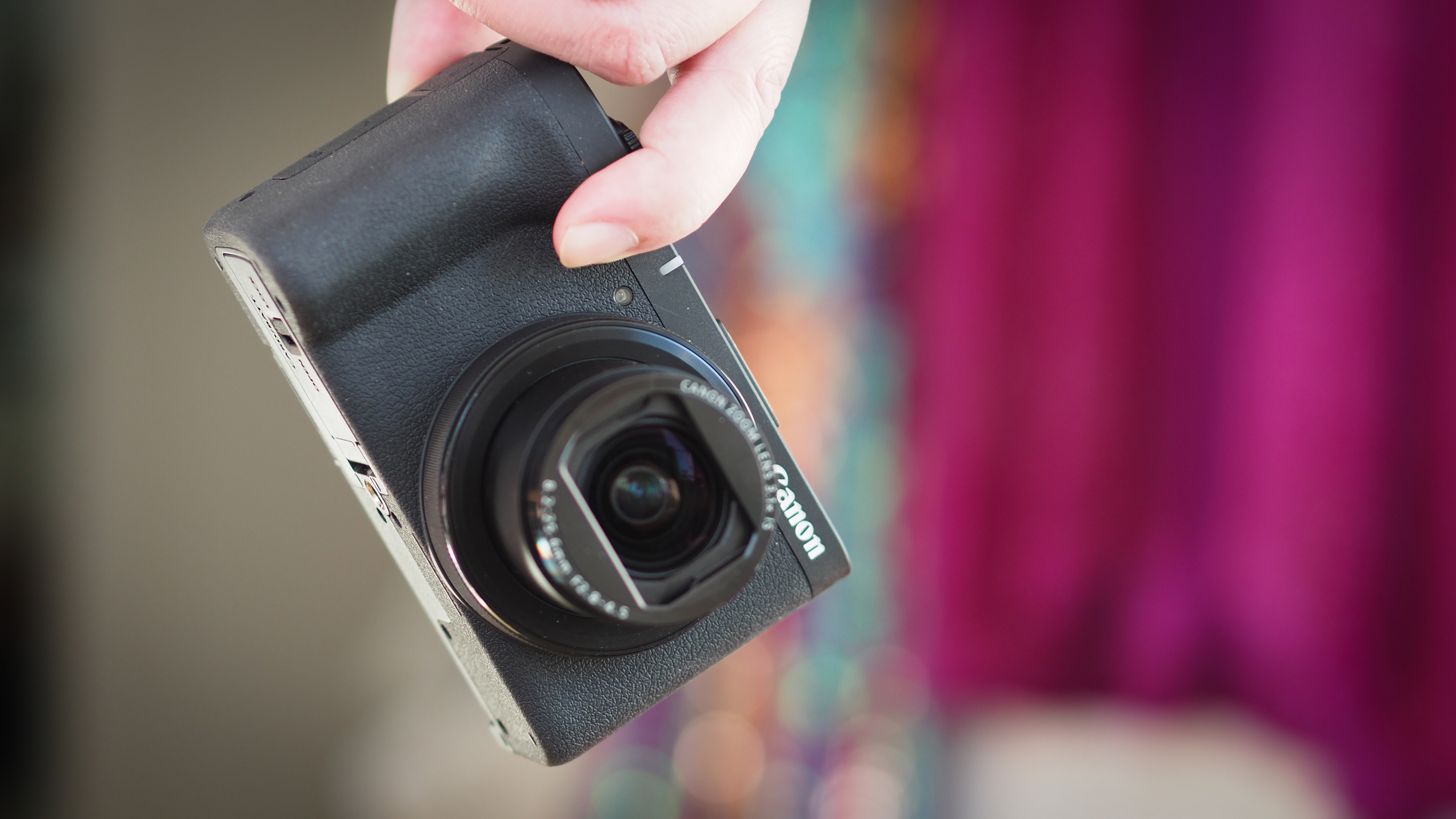 Canon PowerShot being held by fingertips