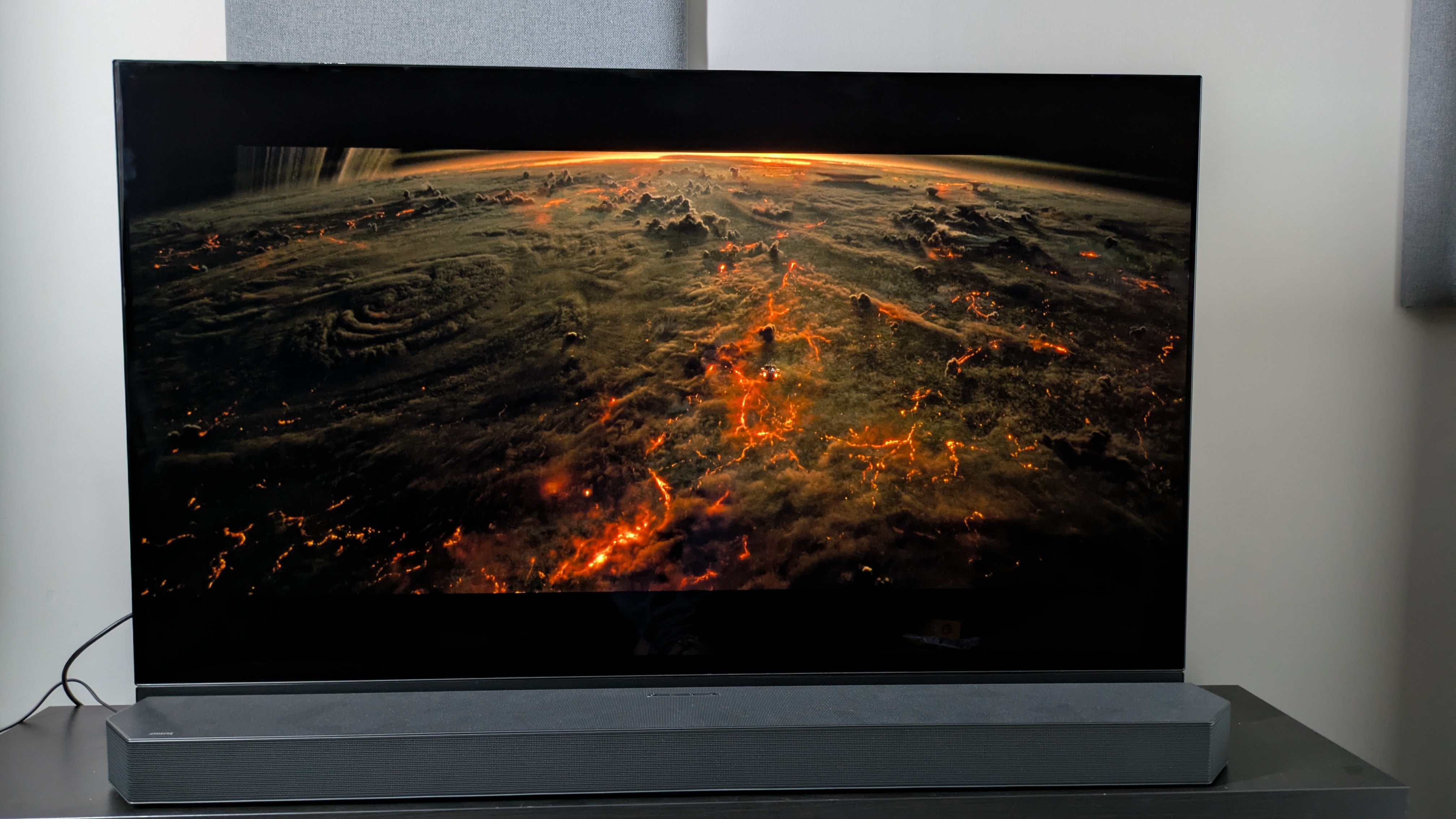 Alien: Romulus image of planet on Panasonic MZ1500 OLED with HW-Q990C soundbar in front of TV