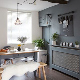 open plan kitchen dining room with charcoal grey wall with chalkboard