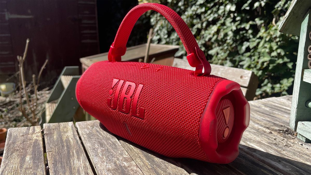 Red JBL Charge 6 wireless speaker on a wooden table
