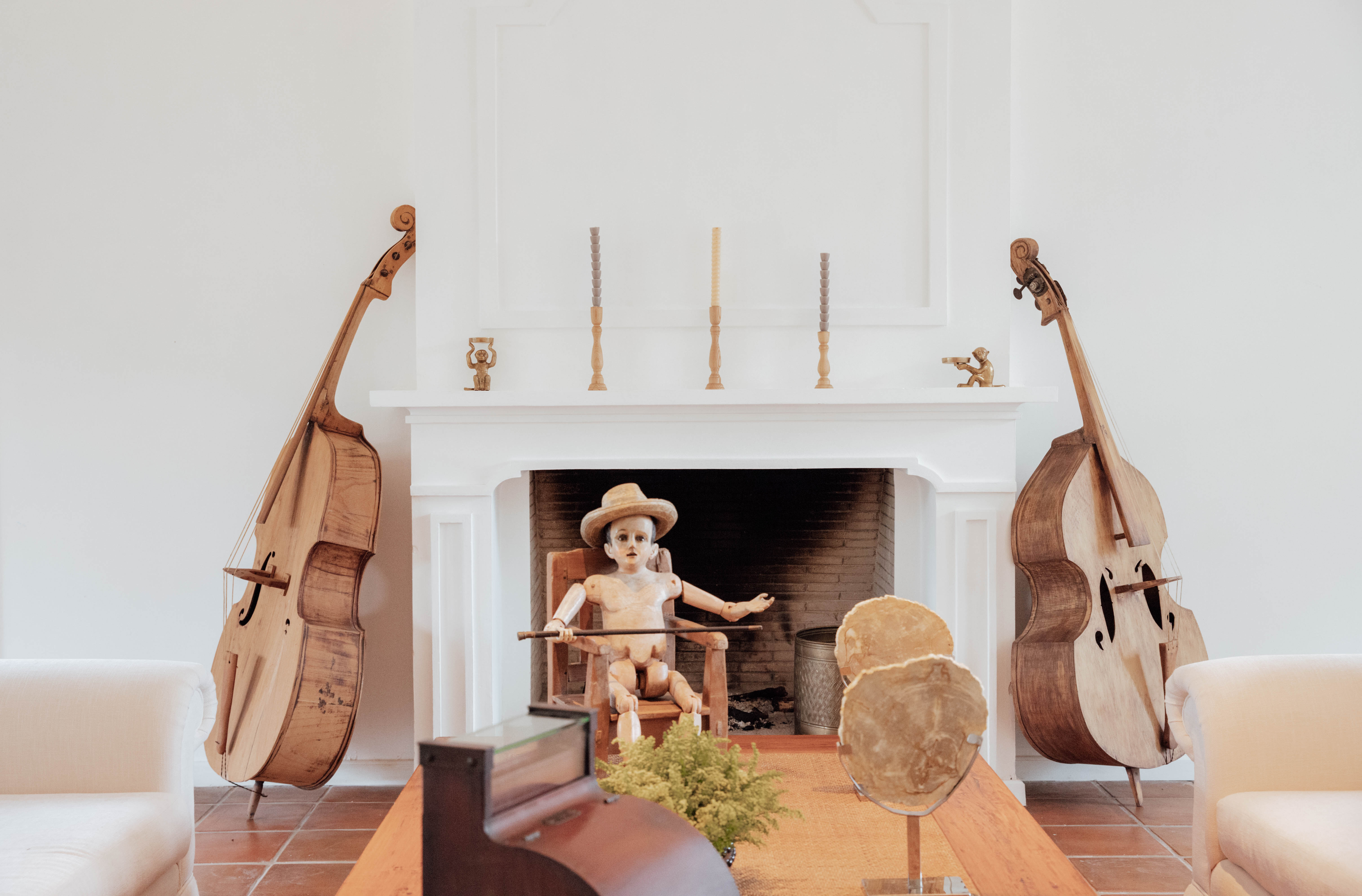 Two large cellos and a doll are among the art works in the lobby at Villa Bokeh