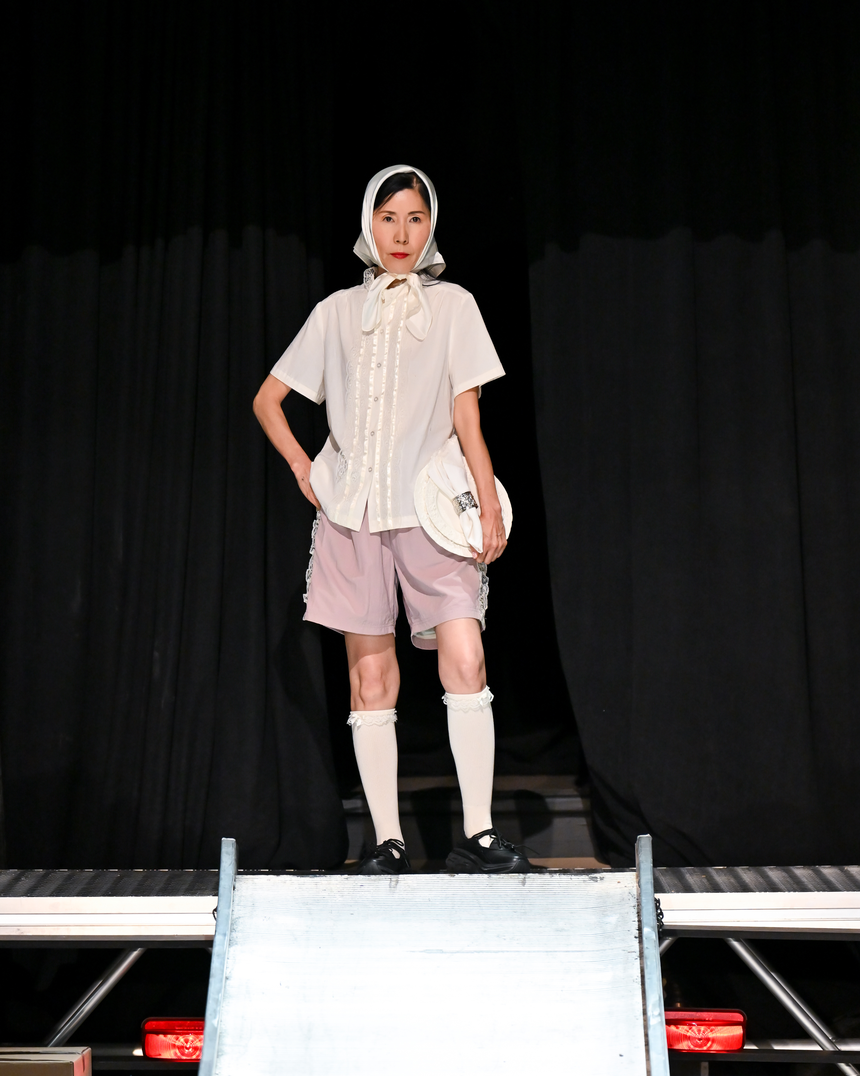 a model on the tanner fletcher runway with hoka sneakers