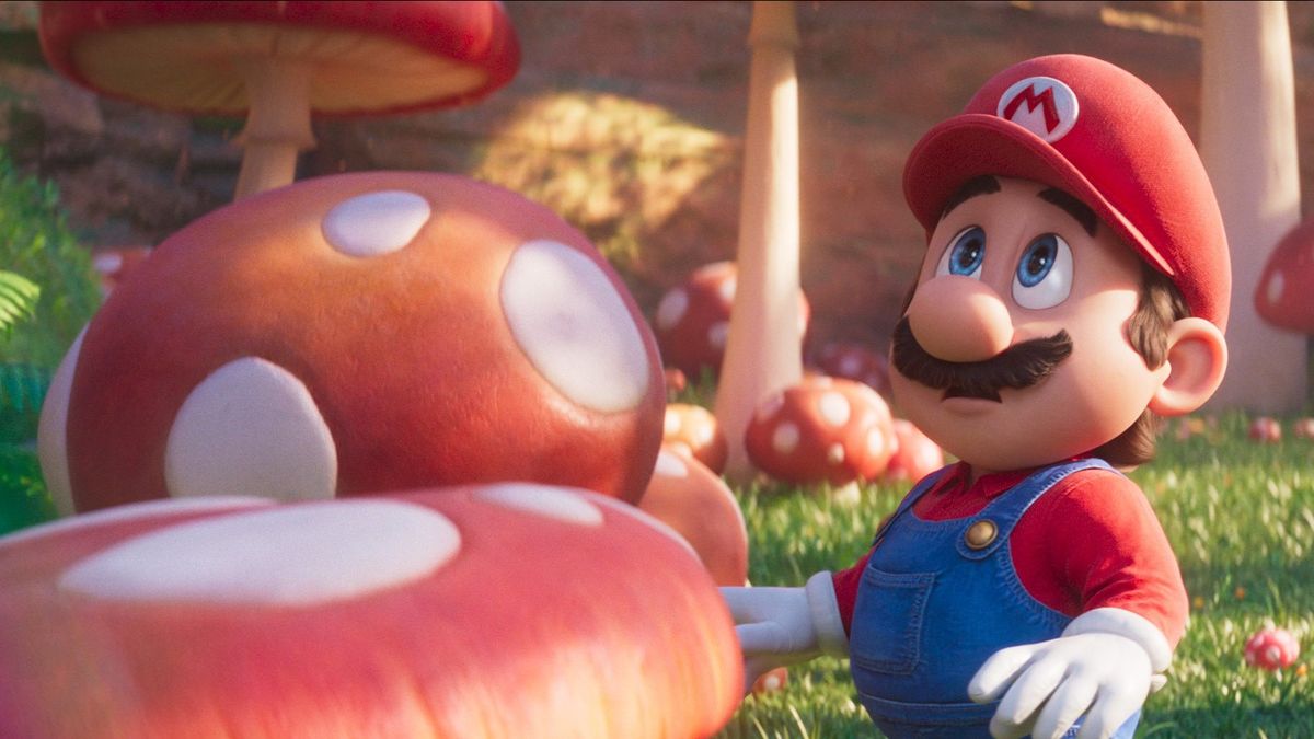 Mario standing beside a mushroom, looking up in shock