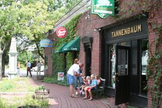 A family sits outside of Tannenbaum, a holiday decor store, in Omaha's Old Market district