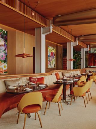 The 1970s-inspired interiors of abc kitchens at The Emory, punctuated by wavy lines, leathery and wooden surfaces, floral artworks, and industrial accents