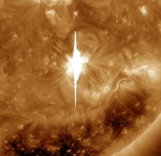 A zoomed-in look at the massive Valentine's Day solar eruption, taken by NASA's Solar Dynamics Observatory in ultraviolet light. Much of the vertical line in the image is caused by the bright flash overwhelming the SDO imager.