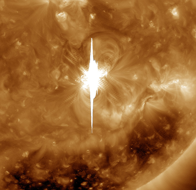 A zoomed-in look at the massive Valentine&#039;s Day solar eruption, taken by NASA&#039;s Solar Dynamics Observatory in ultraviolet light. Much of the vertical line in the image is caused by the bright flash overwhelming the SDO imager.