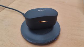 The Sony WF-1000XM4 being wirelessly charged
