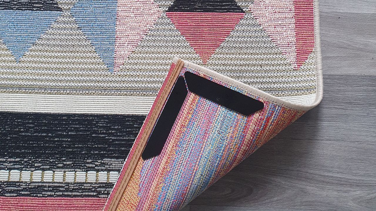 Amazon rug grippers applied to a patterned rug on top of a kitchen lino flooring