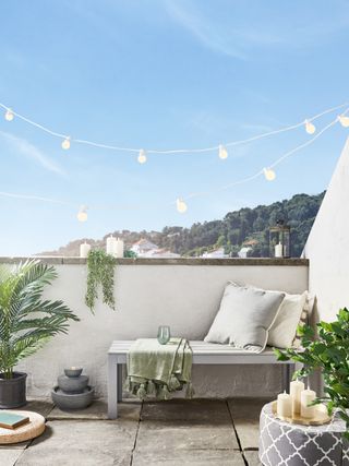 balcony space with festoon lights, candles and lanterns