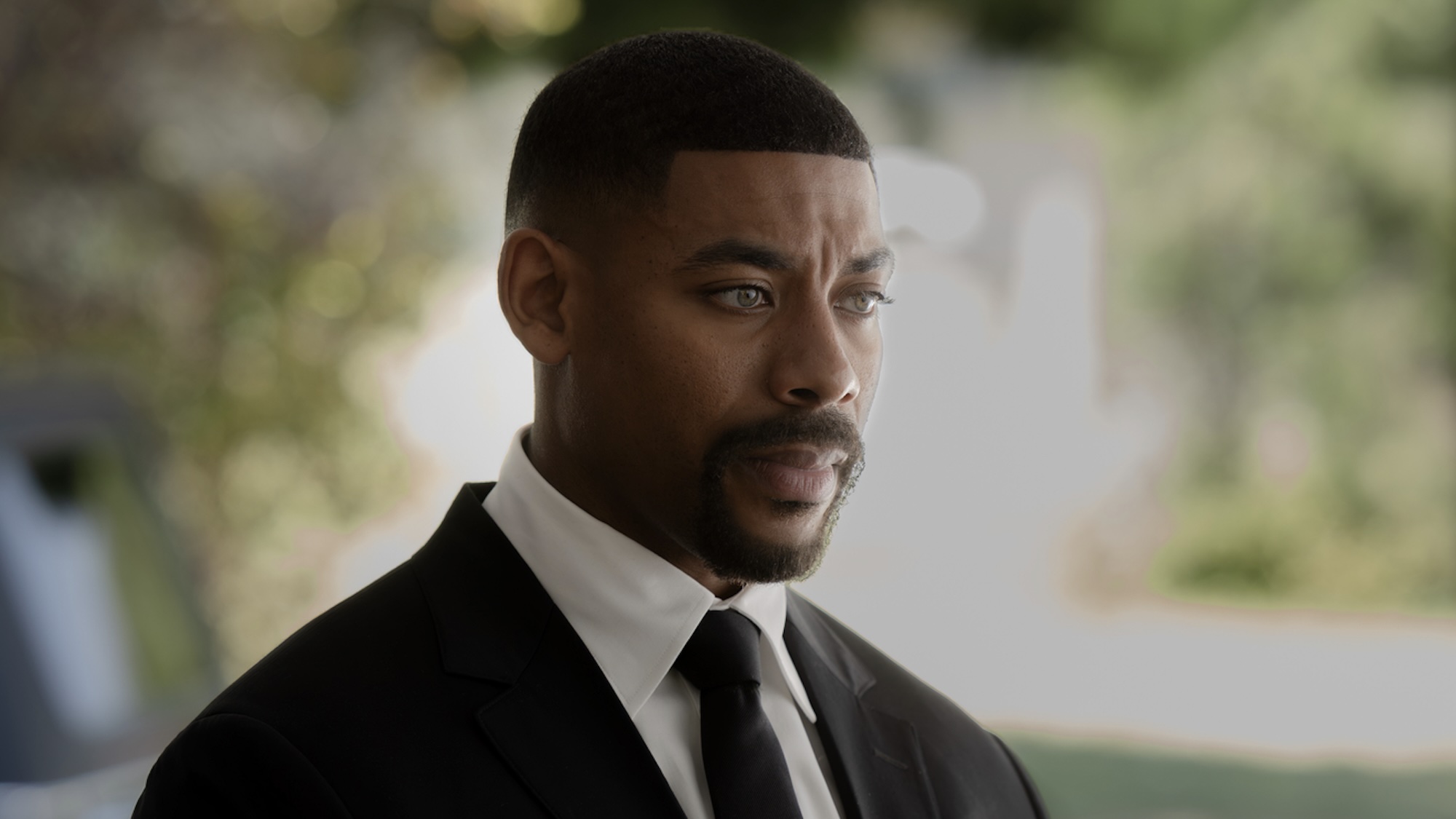 John Stewart in suit for Hal's funeral in Lanterns Episode 5