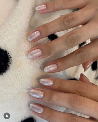 A photo of Selena Gomez wearing silver shimmer nail polish