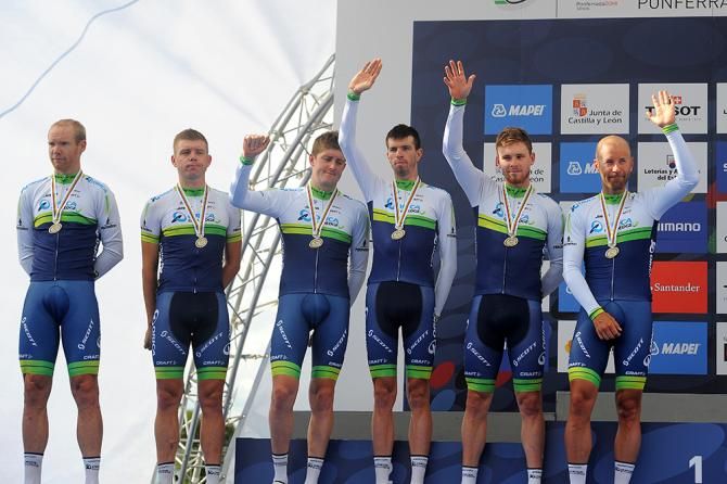 Orica-GreenEdge riders manage a consolatory wave on the podium