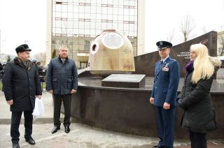 Roscosmos cosmonaut Aleksey Ovchinin (at far left) and NASA astronaut Nick Hague (second from right) are joined by Roscosmos director general Dmitry Rogozin and NASA astronaut Kate Rubins at the dedication of a monument to the Soyuz MS-10 aborted space mission outside of Roscosmos' headquarters in Moscow, Russia, on Monday, Dec. 2, 2019.