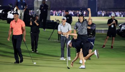 Thomas holes a putt while Spieth, Tiger and Rory look on