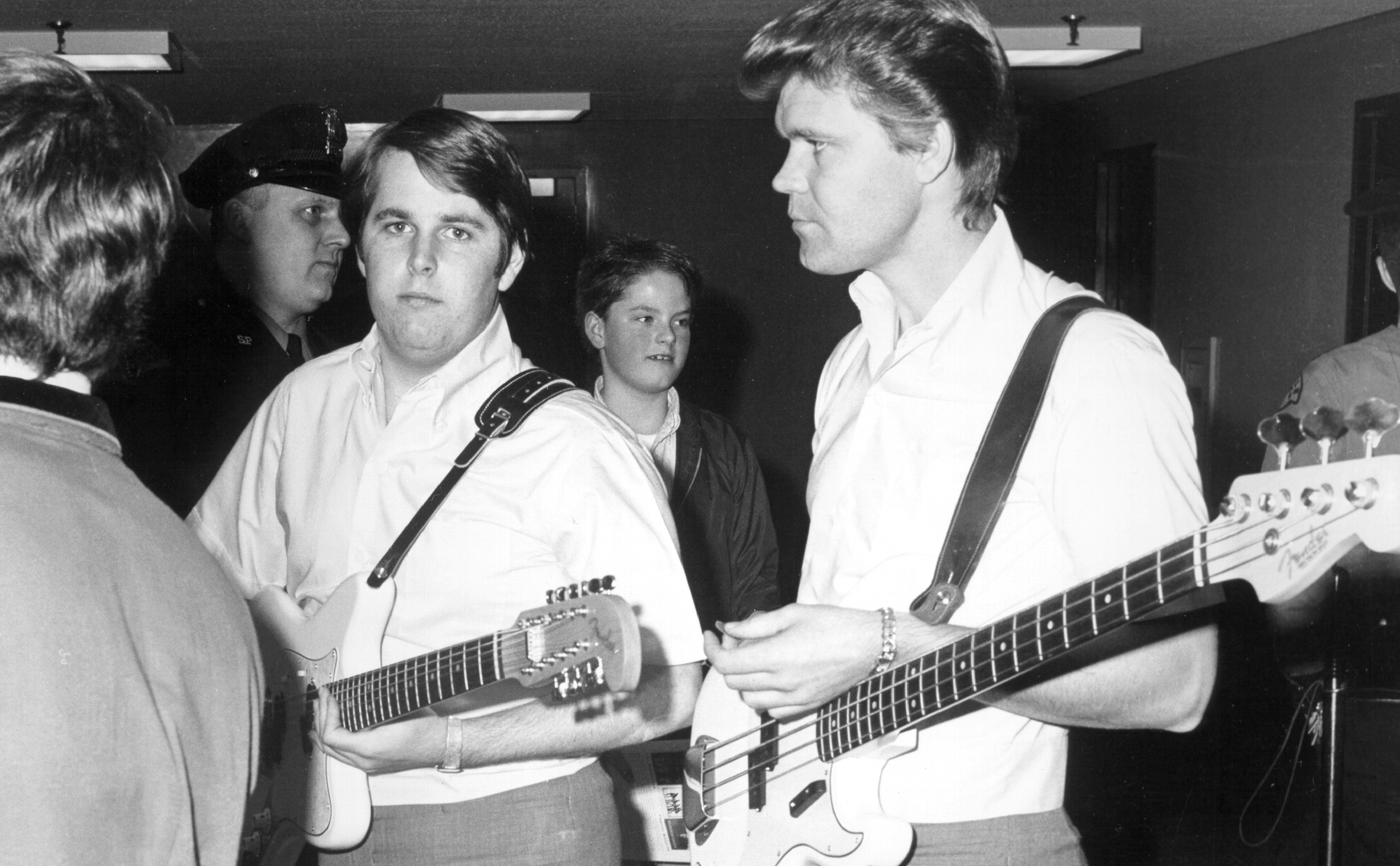 Singer Glen Campbell and guitarist Carl Wilson of the rock and roll band "The Beach Boys" waiting backstage for a performance in 1965. Campbell replaced Brian Wilson as lead singer for performances in 1965.