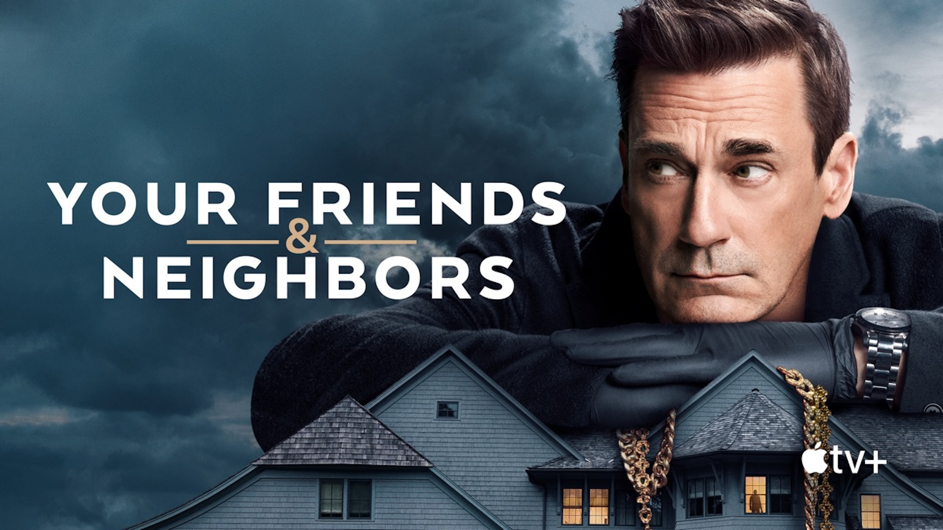 Jon Hamm, enlarged, leaning on top of a house