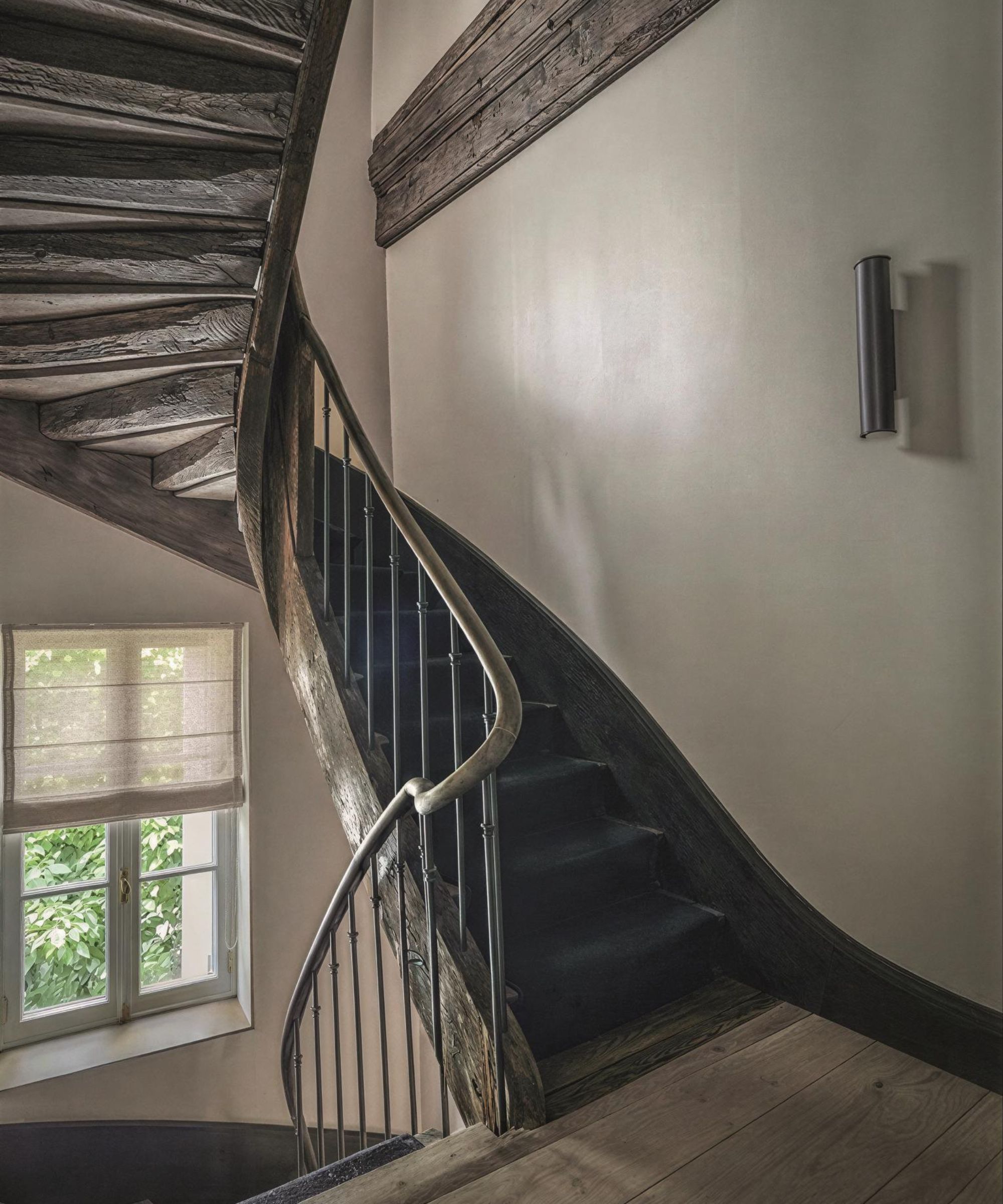 a dramatic original wooden staircase in a townhouse in France