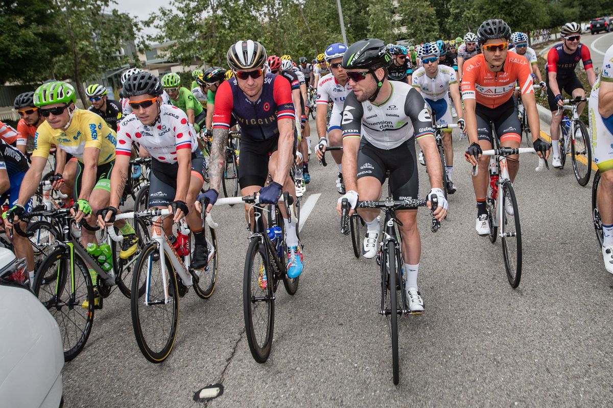 Bradley Wiggins and Mark Cavendish chat as the peloton rolls out