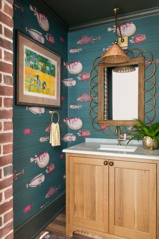 powder room with dark green wallpaper with fish motif