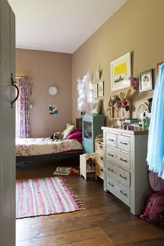 childs bedroom with pretty bedlinen and cabinets