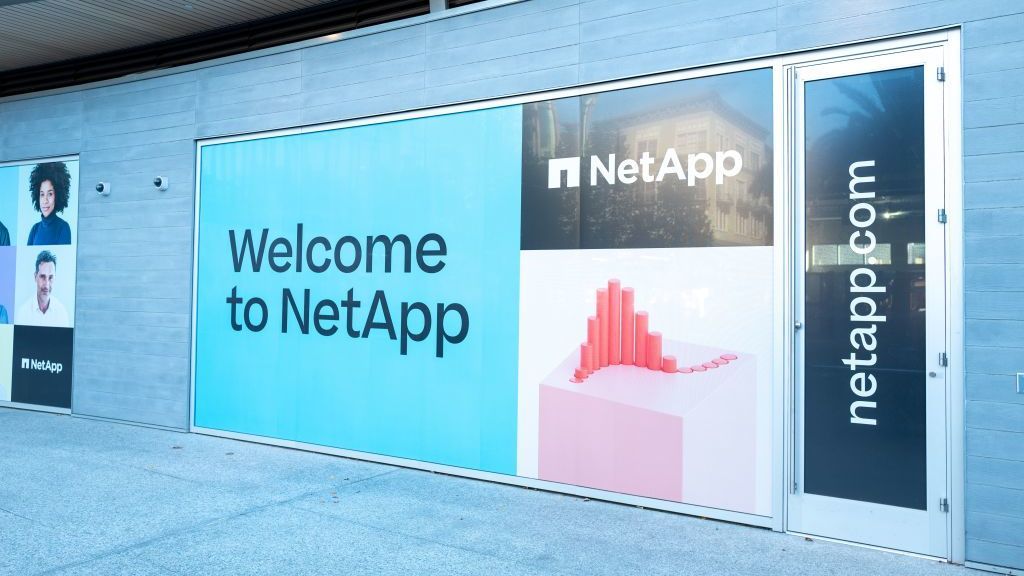 An advert on a wall of a conference building displaying the words &amp;#039;Welcome to NetApp&amp;#039;