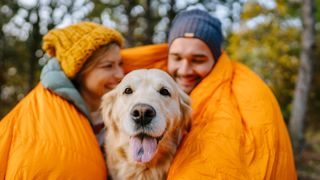 Couple camping with dog