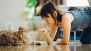 Woman points finger accusingly at cat