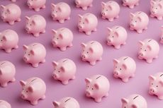 Array of pink piggy banks on pink background