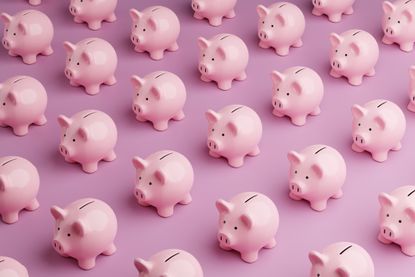 Array of pink piggy banks on pink background