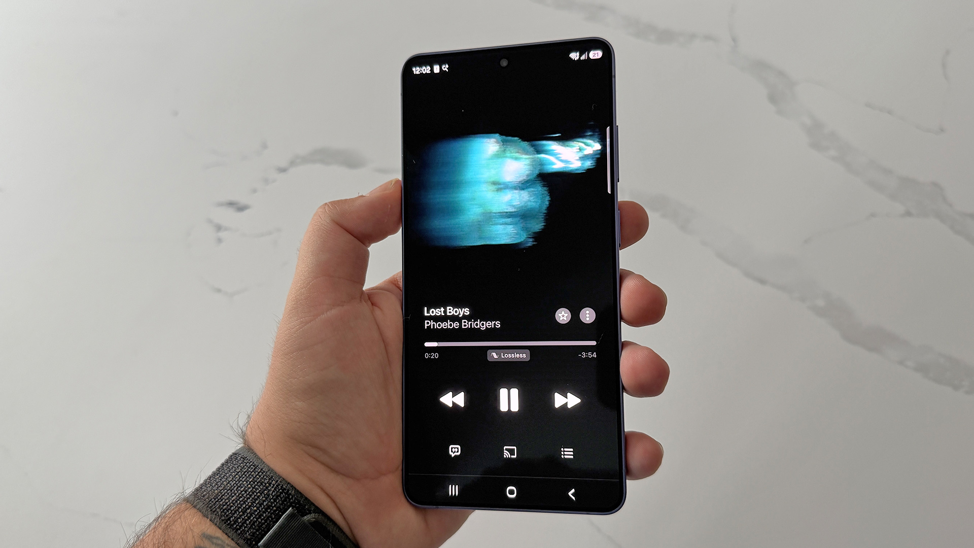Samsung Galaxy S26 Ultra smartphone held in hand playing music with Phoebe Bridgers Lost Boys shown