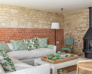 Country style green and white living room in 17th century barn in Dorset
