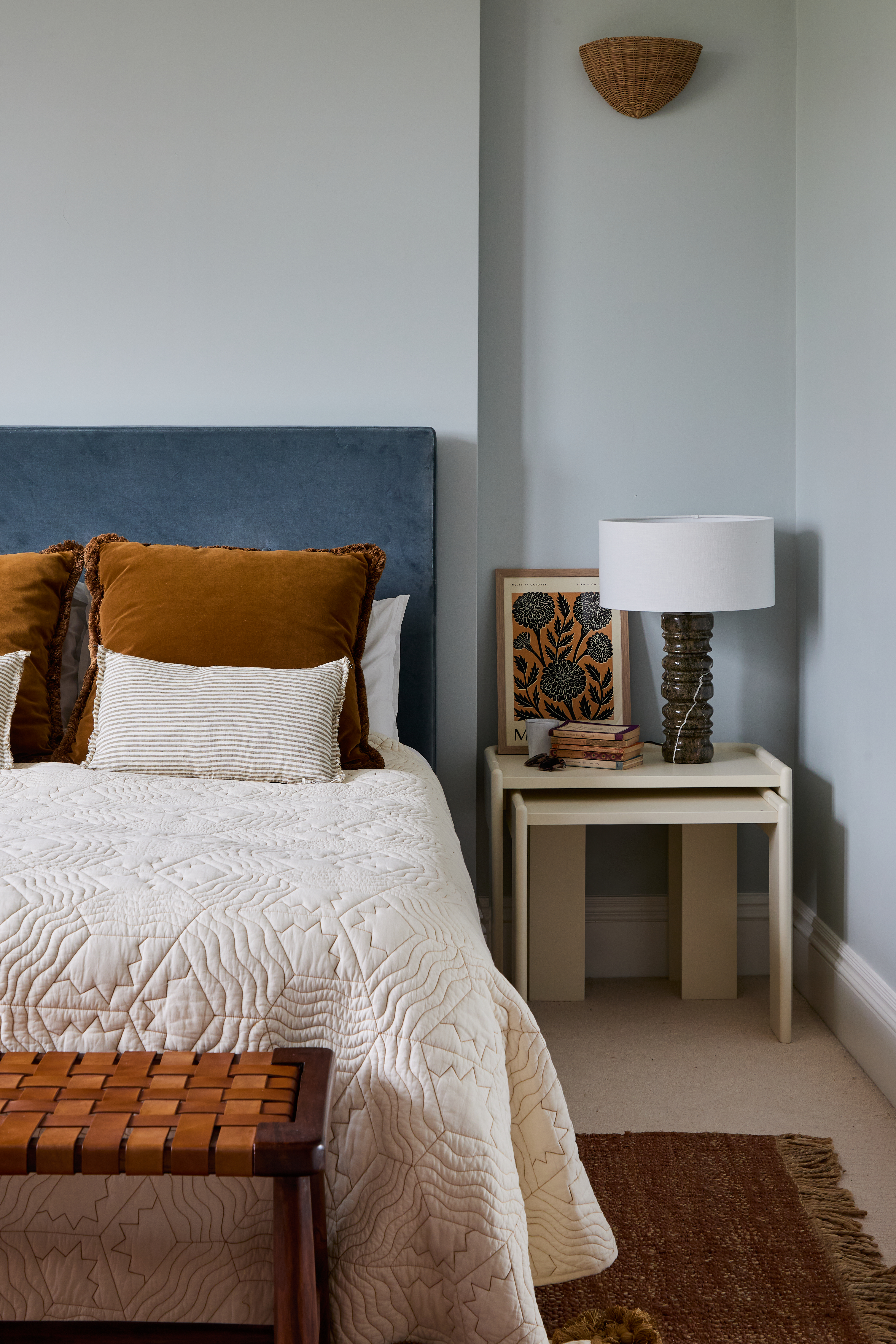 Light blue bedroom with bronze cushions by Imperfect Interiors