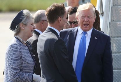 British Foreign Secretary Jeremy Hunt greets Trump outside London