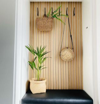 small mudroom/coat rack with wooden slat design and seat