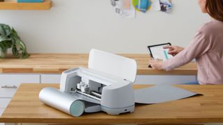 Reasons to get Cricut Access: a photo of a Cricut machine on a kitchen table