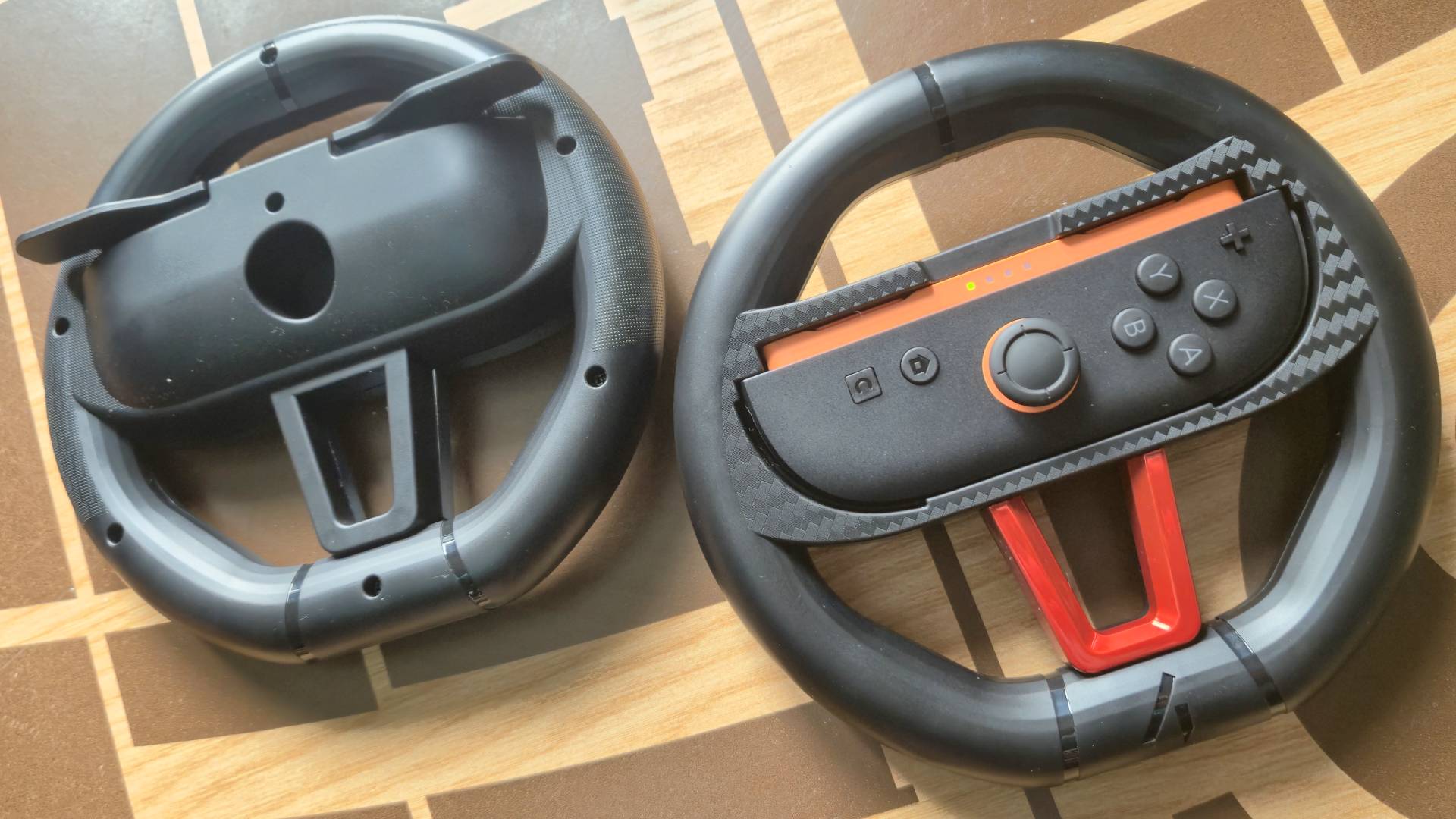Photo by Rosalie Newcombe of the 4gamer (STEALTH) Switch 2 Twin Racing Wheel controllers sitting on a wooden coffee table.