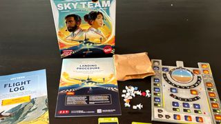 Sky Team box, instruction booklets, board, and tokens laid out on a wooden table