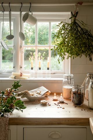 Christmas kitchen decorating ideas with hanging foliage and candles by British Standard by Plain English