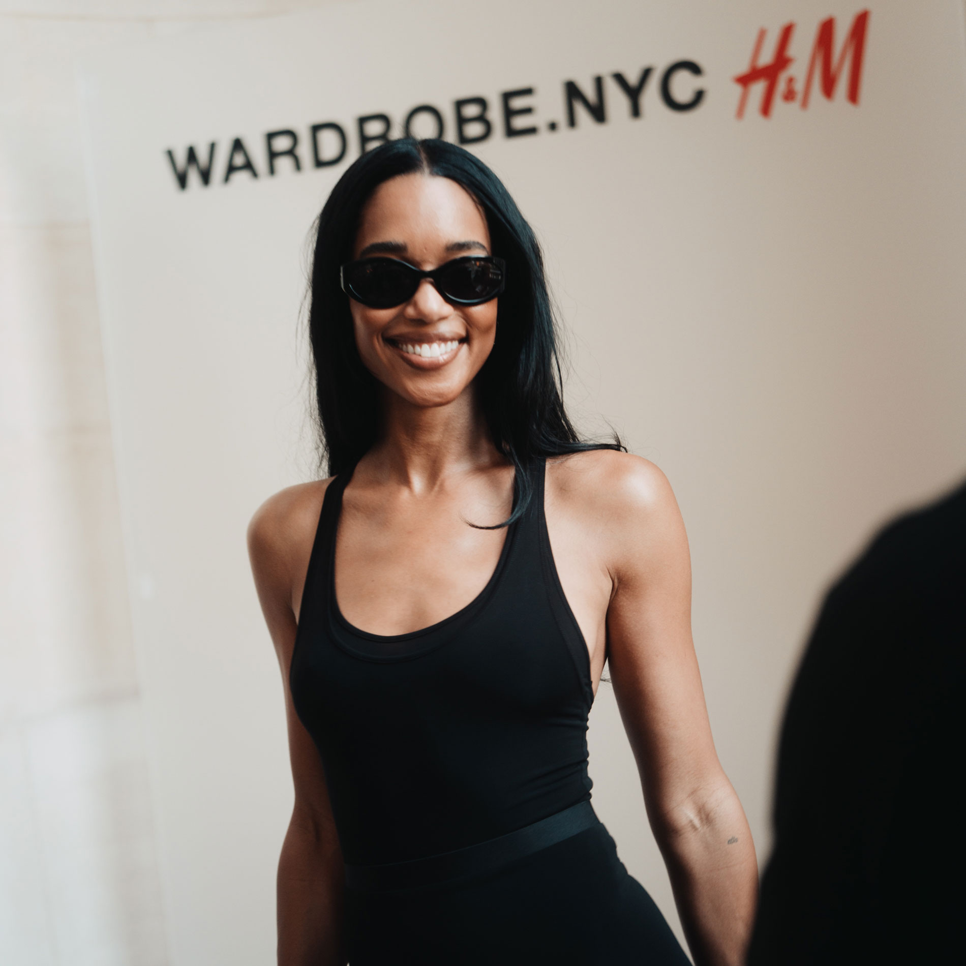 Laura Harrier wears a black dress from the H&M x Wardrobe.NYC collab