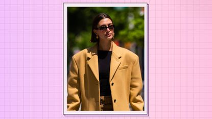 Hailey Bieber pictured walking down the street in NYC, wearing an oversized camel coat and sunglasses - used for a piece on Hailey Bieber's perfume/ in a purple and pink template