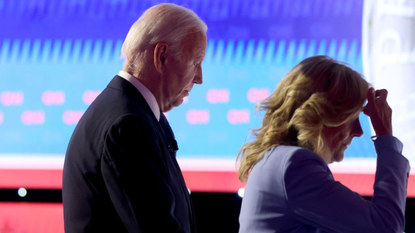 Joe Biden, accompanied by his wife, walks off stage following his televised CNN debate against Donald Trump