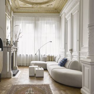 A living room with traditional panelling and modern furniture